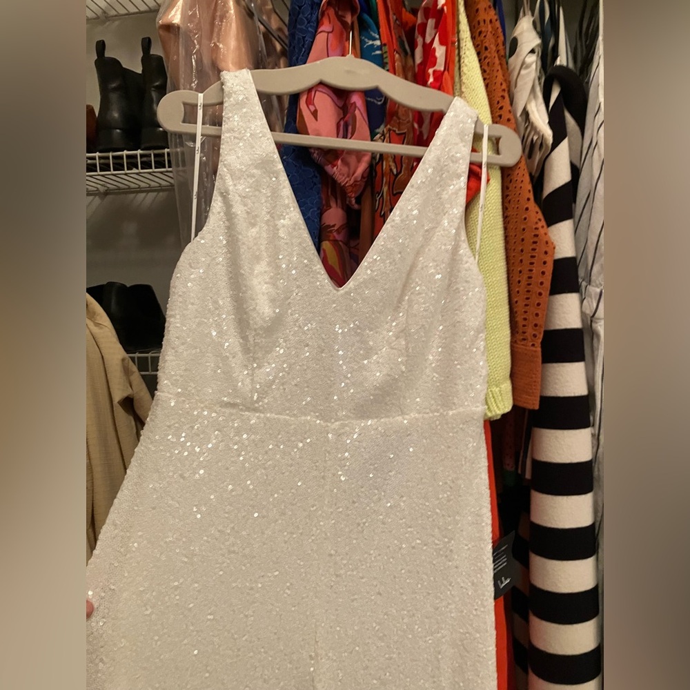 White sequin jumpsuit with bow in back. Bow is detachable.